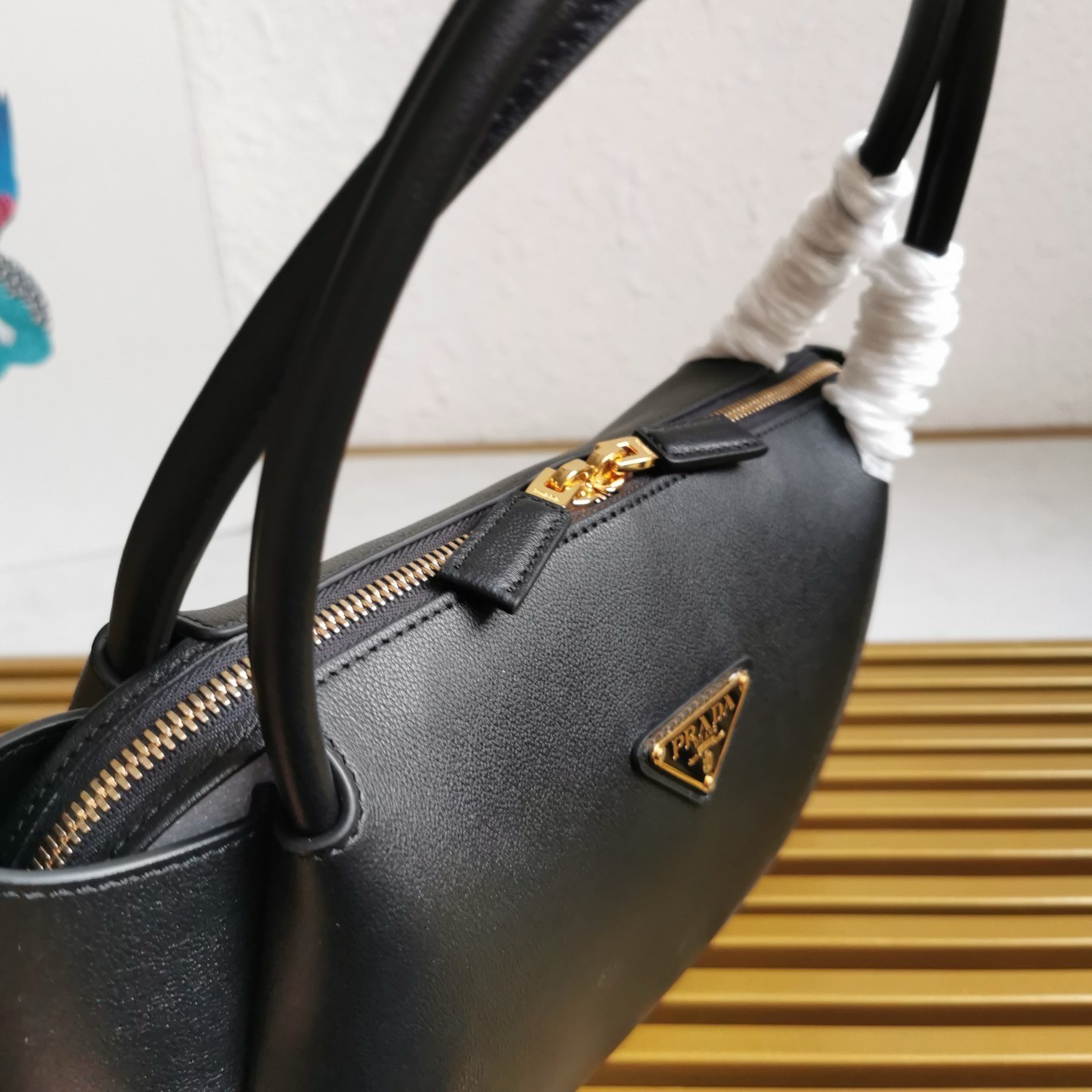 Pra*a shoulder bag in black calfskin with triangle logo