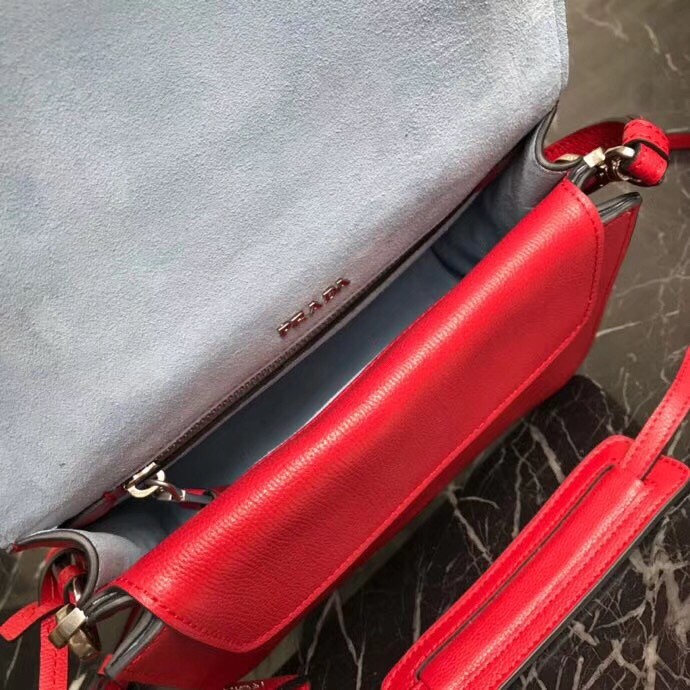 Pra*a etiquette bag in red calfskin with metal stud trim