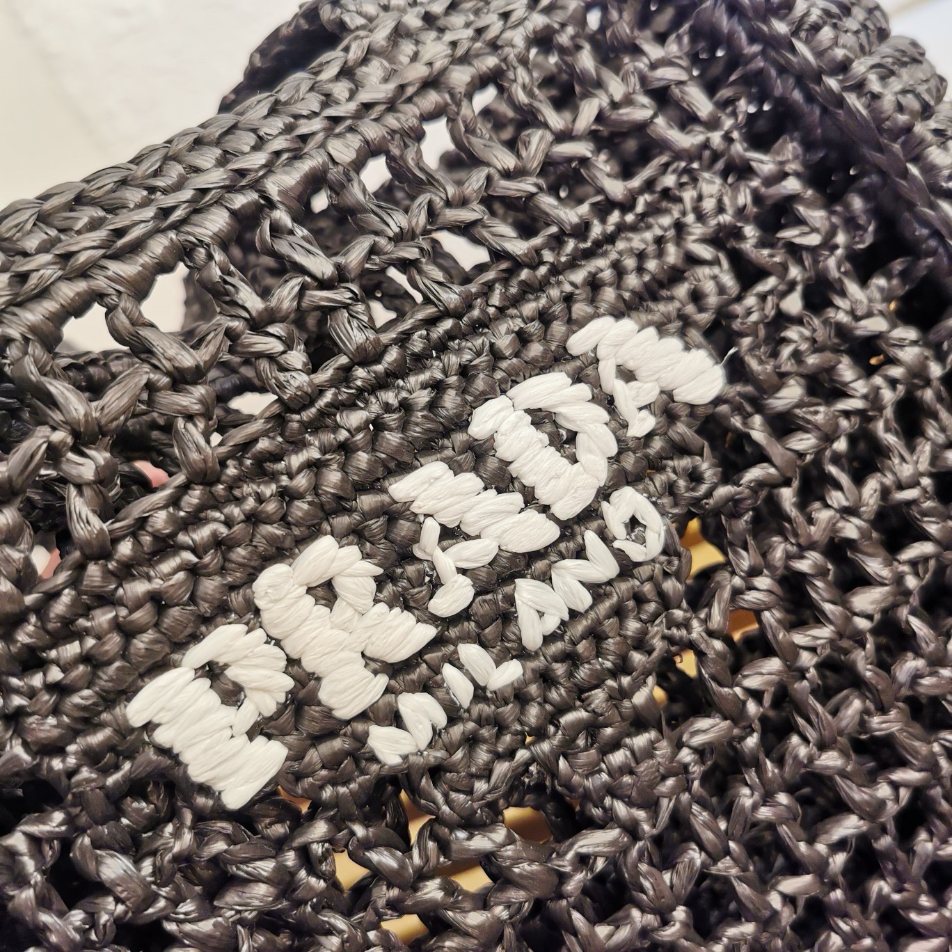 Pra*a small crochet tote in black raffia-effect yarn