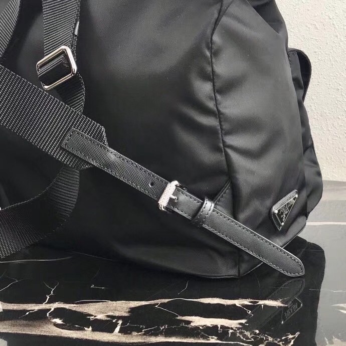 Pra*a black nylon backpack with white metal studs