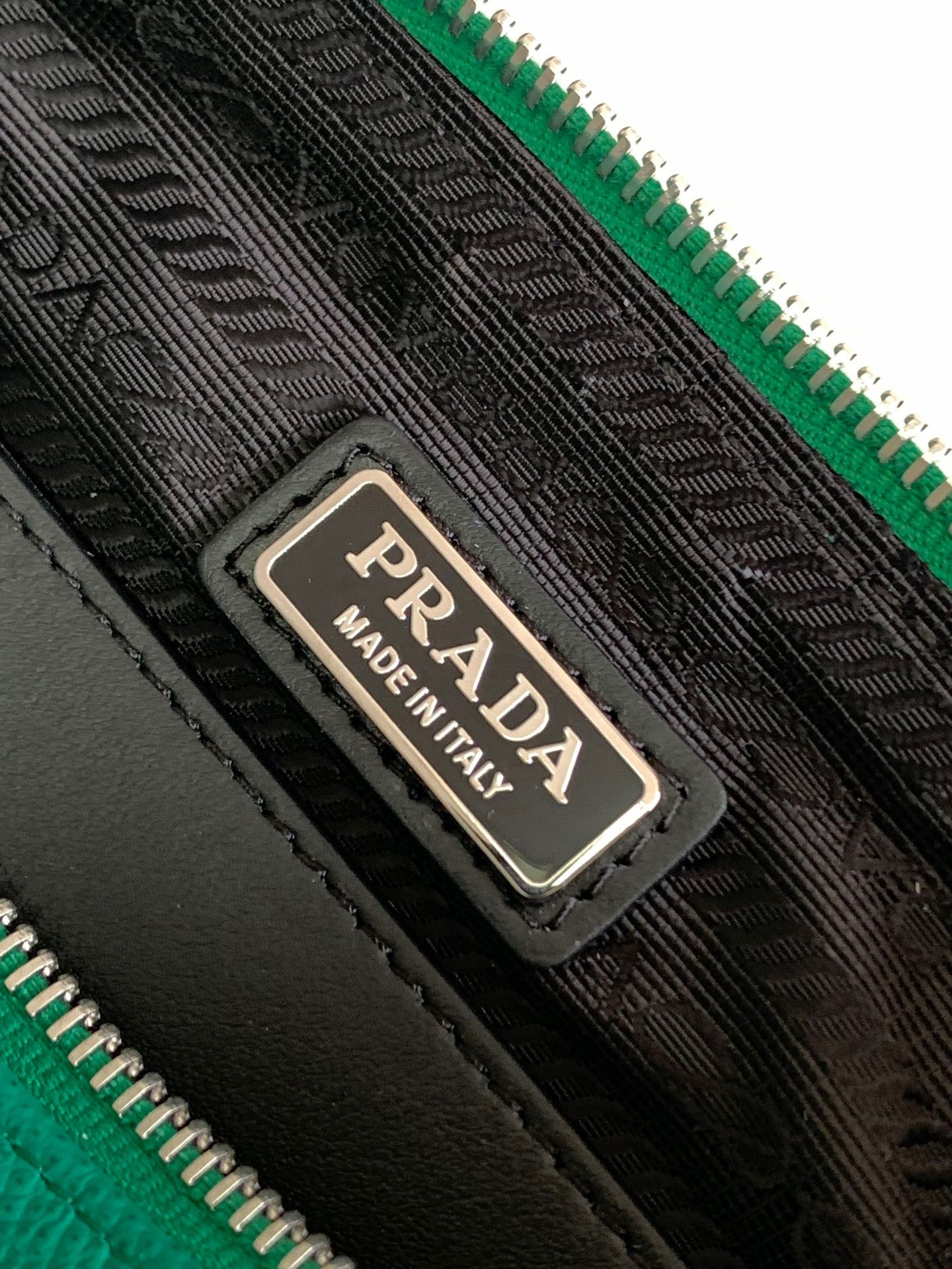Pra*a triangle shoulder bag in green saffiano calfskin