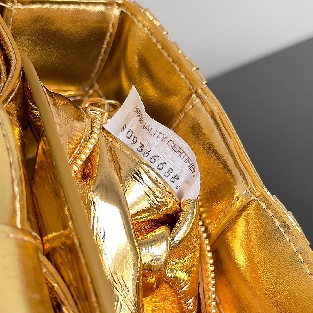 bo*te*ga Ve*ne*ta small cassette bag in gold metallic lambskin