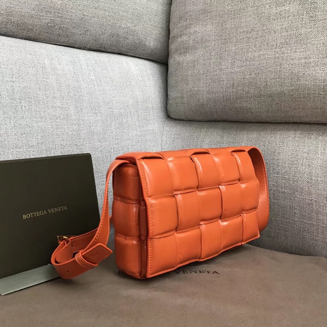 bo*te*ga Ve*ne*ta padded cassette bag in orange calfskin