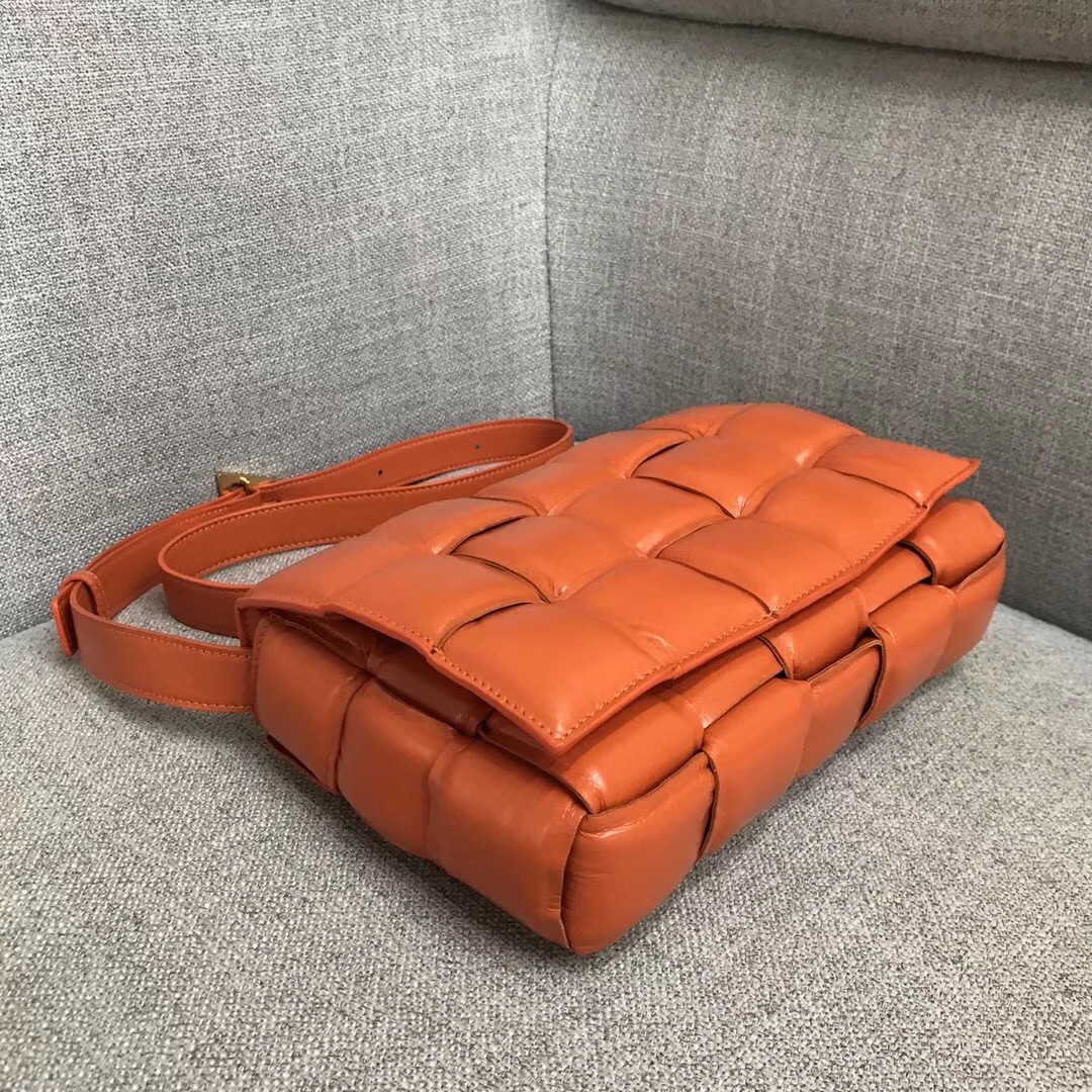 bo*te*ga Ve*ne*ta padded cassette bag in orange calfskin