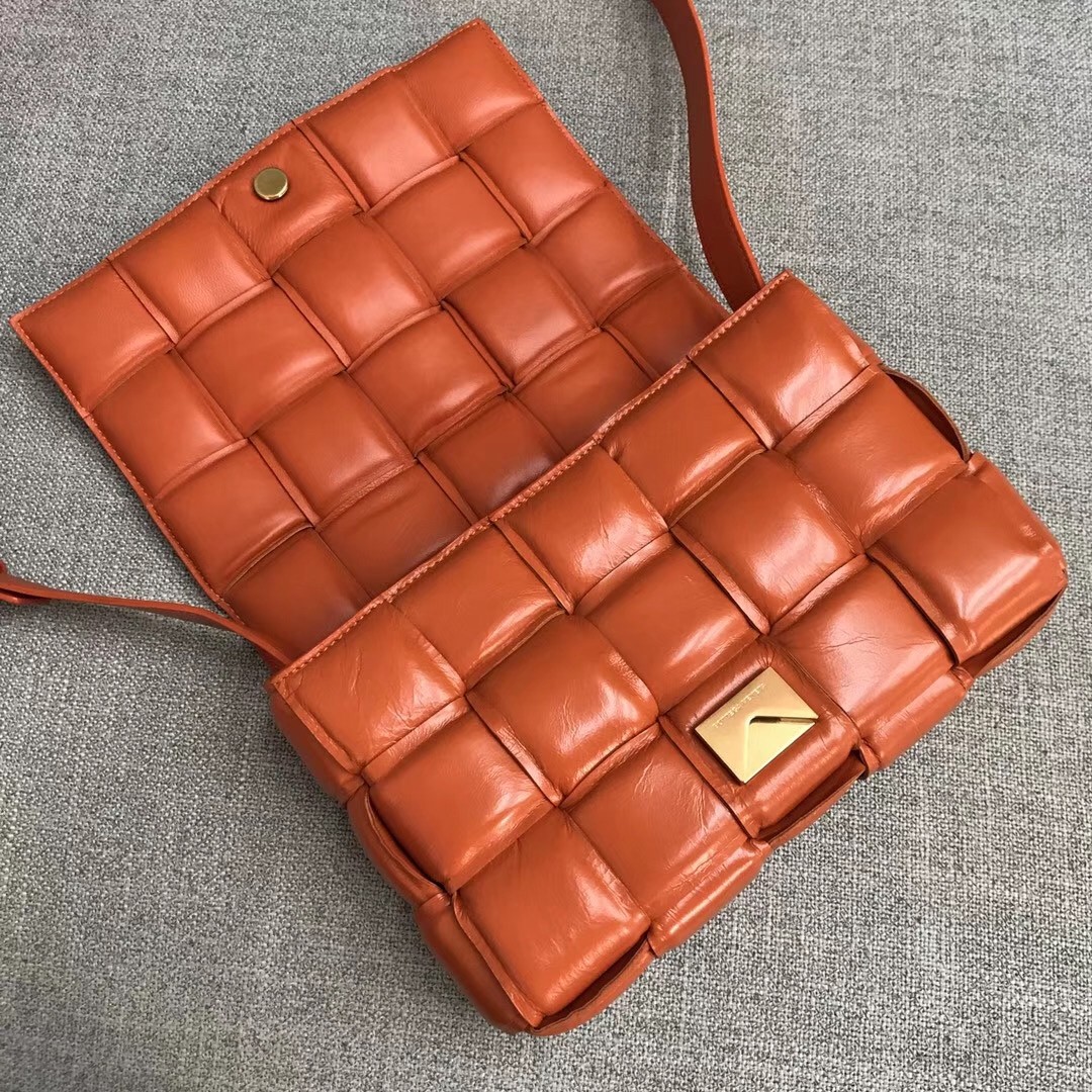 bo*te*ga Ve*ne*ta padded cassette bag in orange calfskin