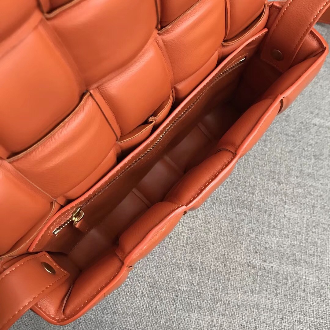 bo*te*ga Ve*ne*ta padded cassette bag in orange calfskin