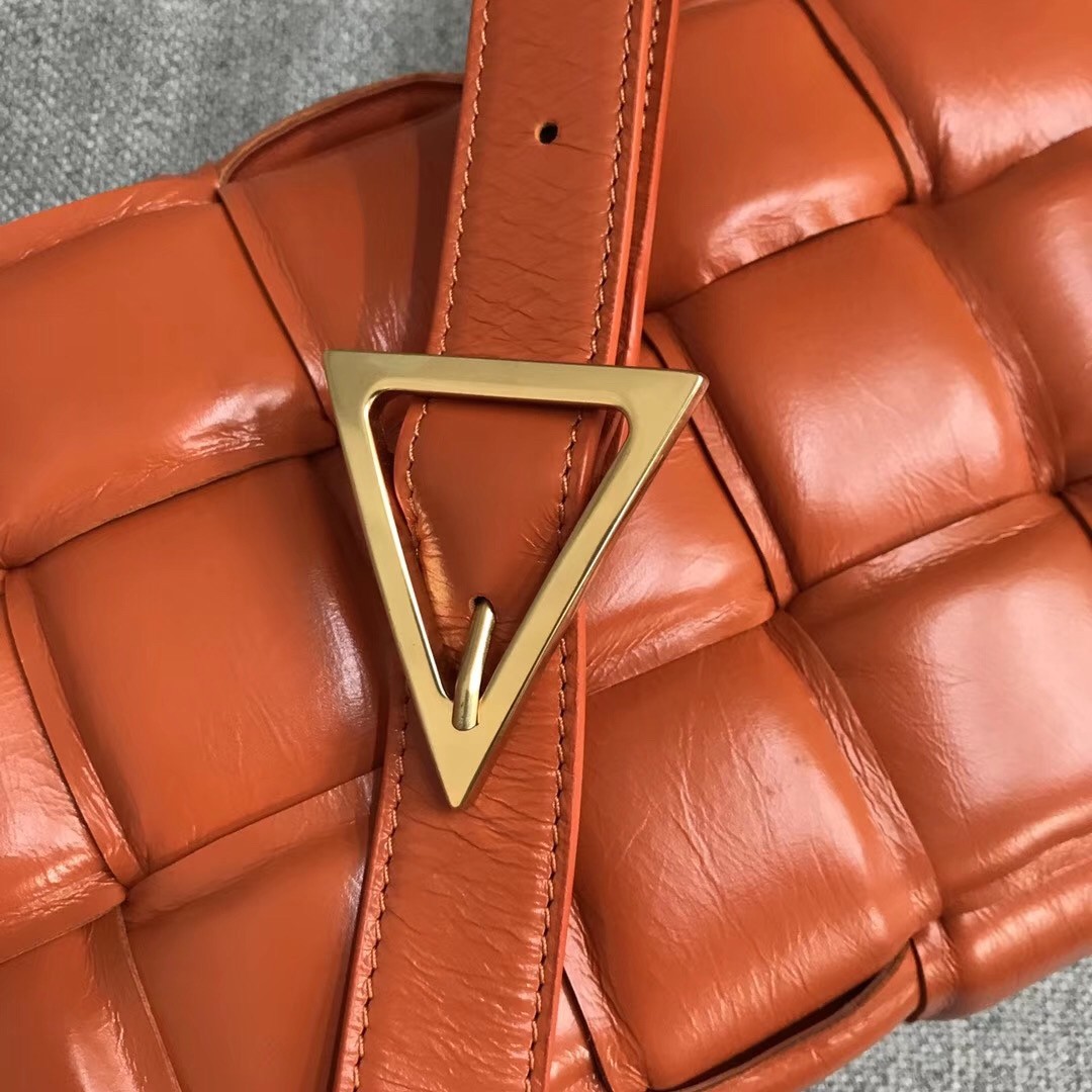 bo*te*ga Ve*ne*ta padded cassette bag in orange calfskin
