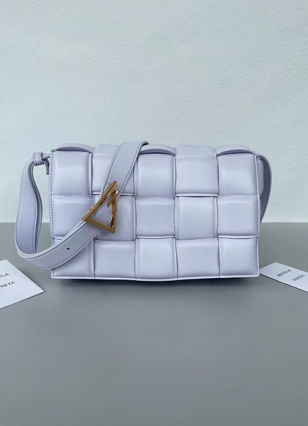 bo*te*ga Ve*ne*ta padded cassette bag in lilas lambskin