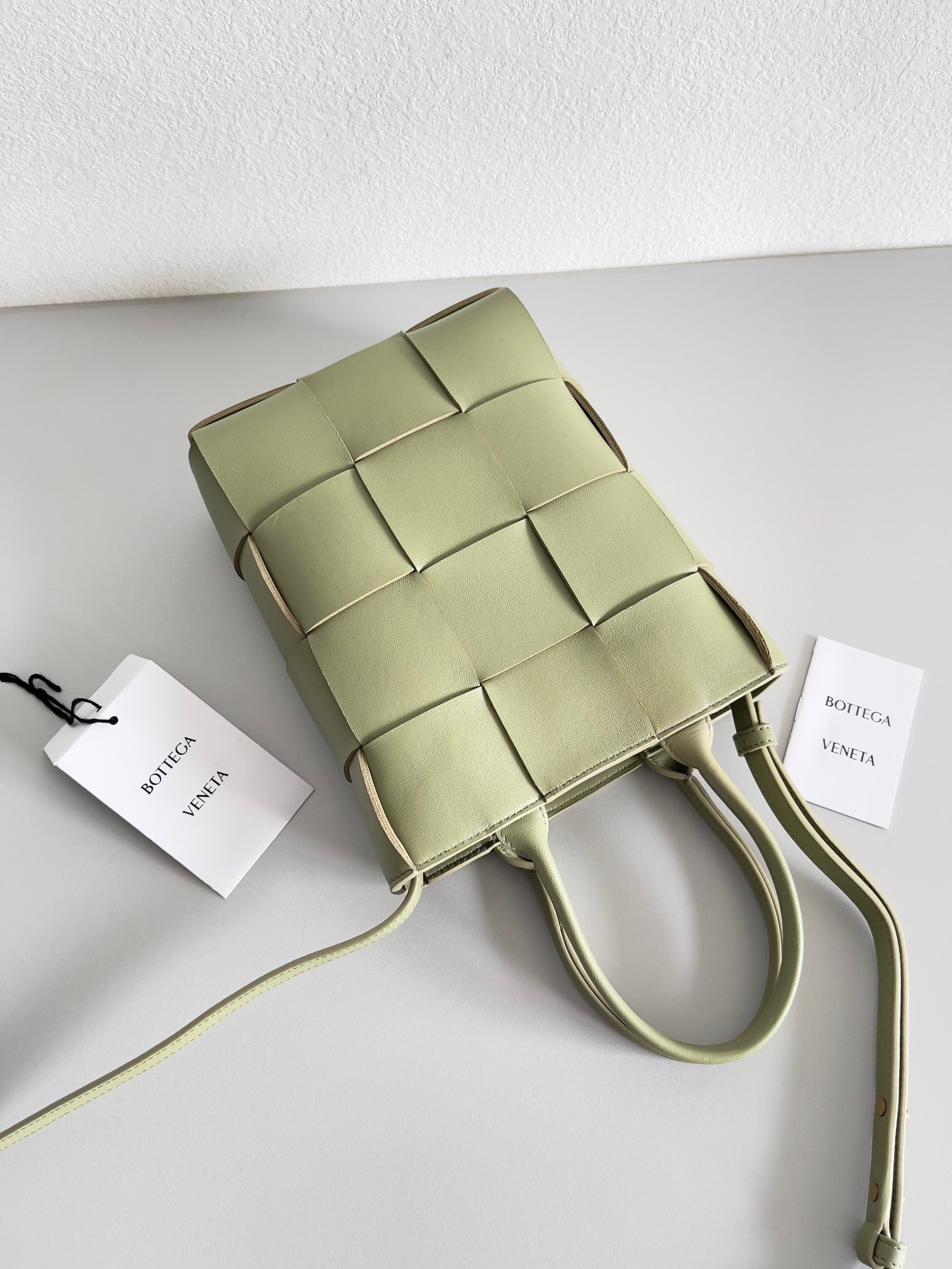 bo*te*ga Ve*ne*ta mini cassette tote bag in travertine lambskin