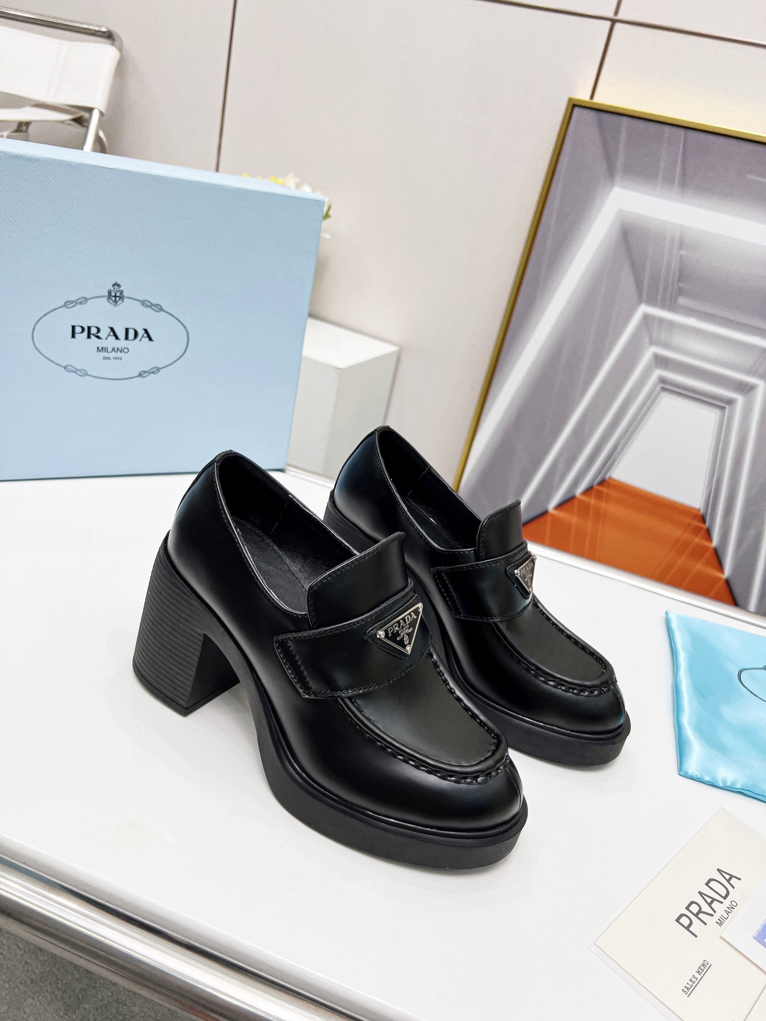 Pra*a chocolate high-heeled loafers in black brushed leather