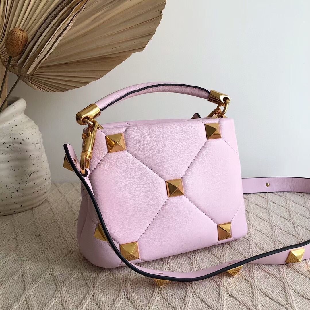 Va1e*ntin0 small roman stud top handle bag in pink nappa