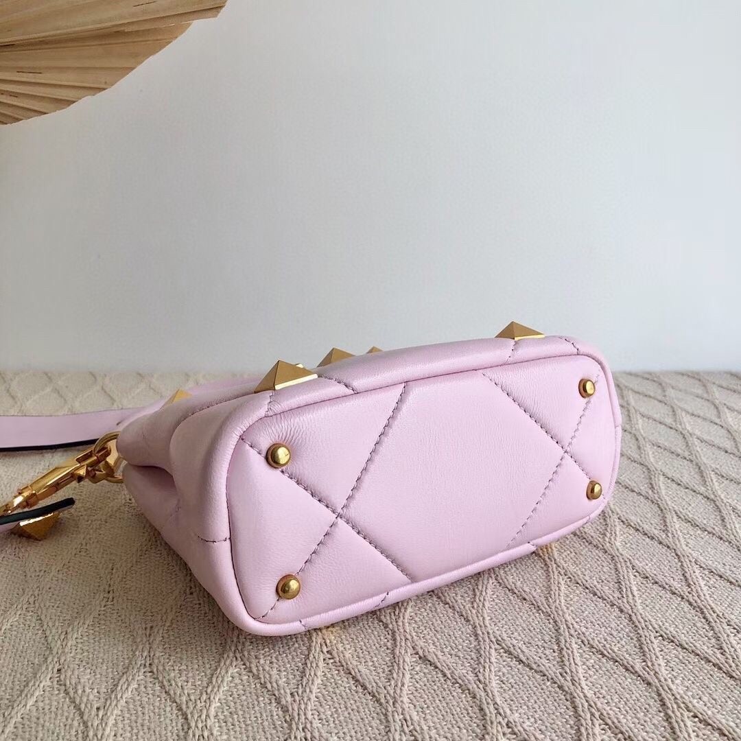 Va1e*ntin0 small roman stud top handle bag in pink nappa