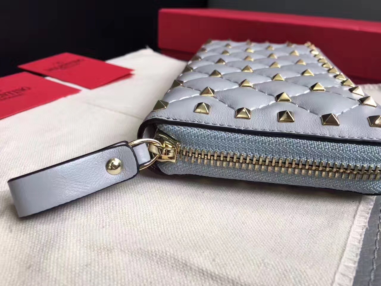 Va1e*ntin0 rockstud spike zip wallet in sky blue lambskin